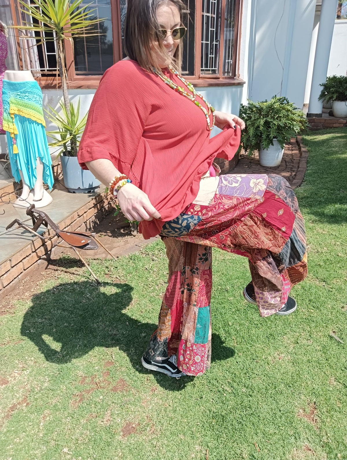 Patchwork Bell Bottom Pants - lifting top to show waistband and pockets