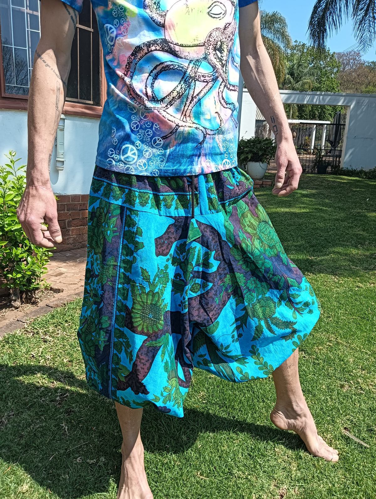 Tropical Print Aladdin Harem Pants in Teal Blue — side view showing balloon silhouette