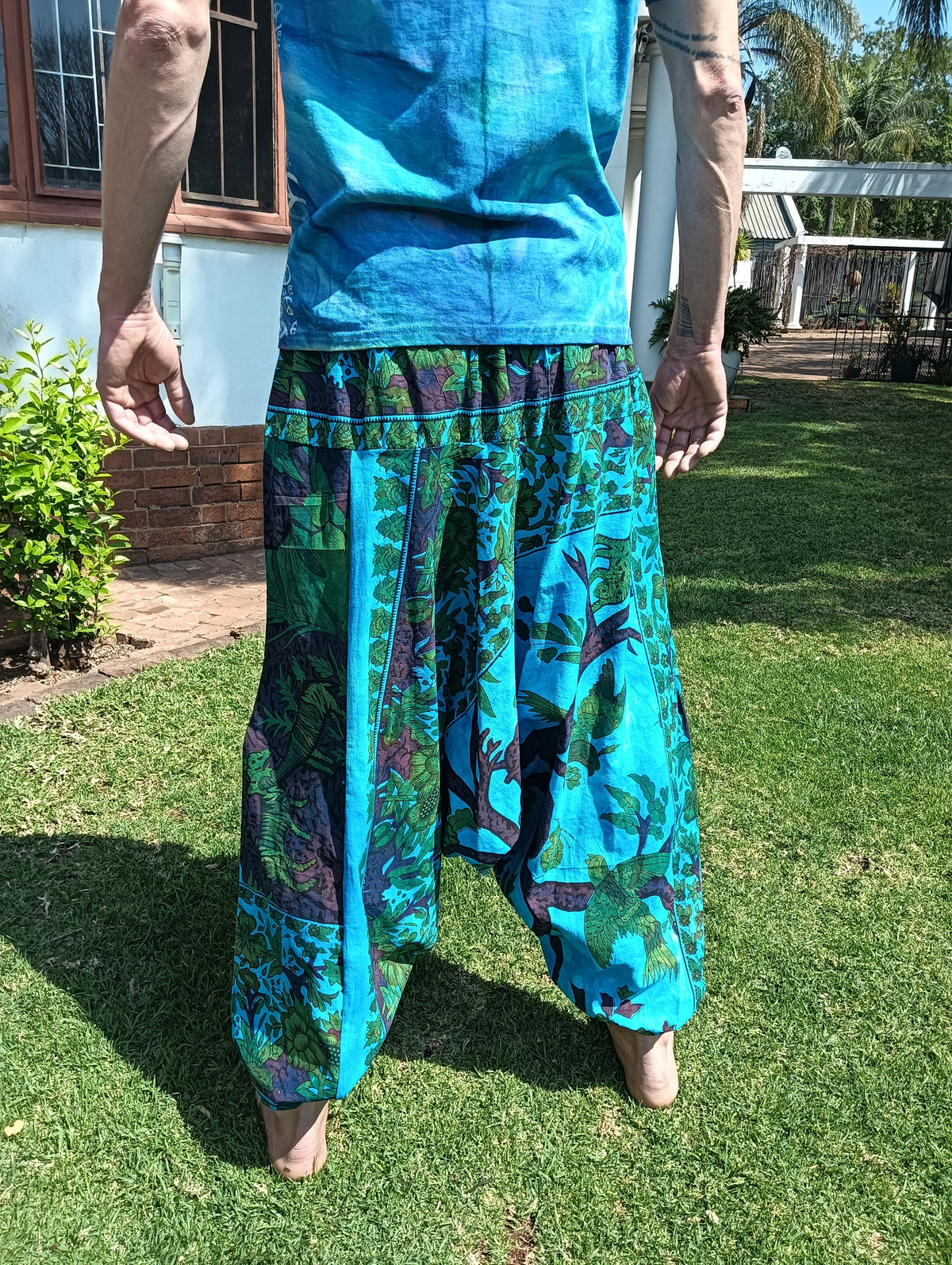 Tropical Print Aladdin Harem Pants in Teal Blue — back view