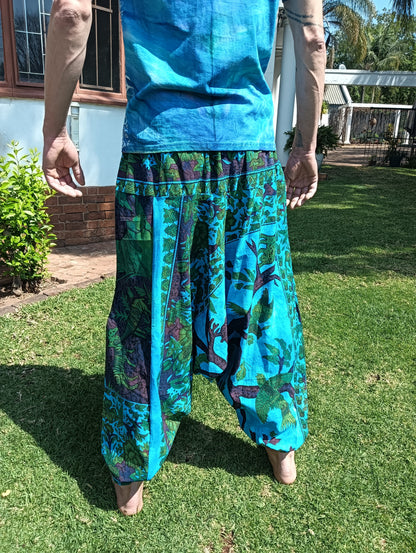 Tropical Print Aladdin Harem Pants in Teal Blue — back view