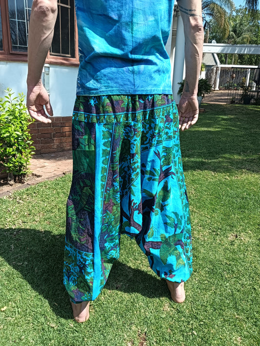 Tropical Print Aladdin Harem Pants in Teal Blue — back view