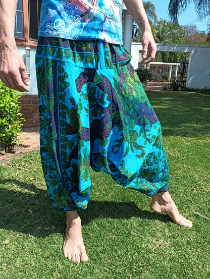 Tropical Print Aladdin Harem Pants in Teal Blue — front view showing drape