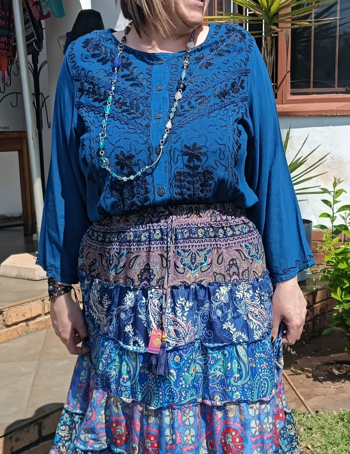 Embroidered Viscose Long Sleeve Blouse in Teal – full front view showing dense black embroidery and ruffle button placket