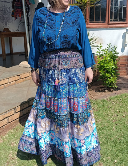 Gypsy Tiered Maxi Skirt styled with Embroidered Viscose Blouse – three-quarter view showing full skirt sway