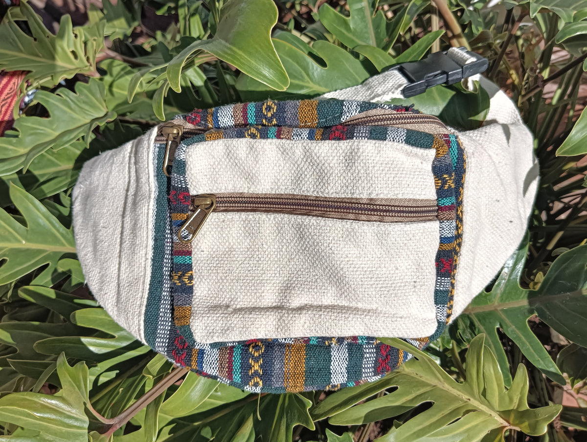 Nepali Hemp Moonbag flat lay — front view showing natural hemp body, tapestry border and clip buckle