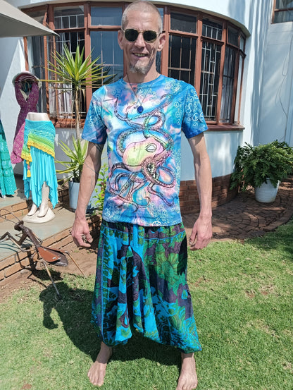 UV Glow Octopus Tie-Dye T-Shirt – full length on male model styled with turquoise print aladdin pants