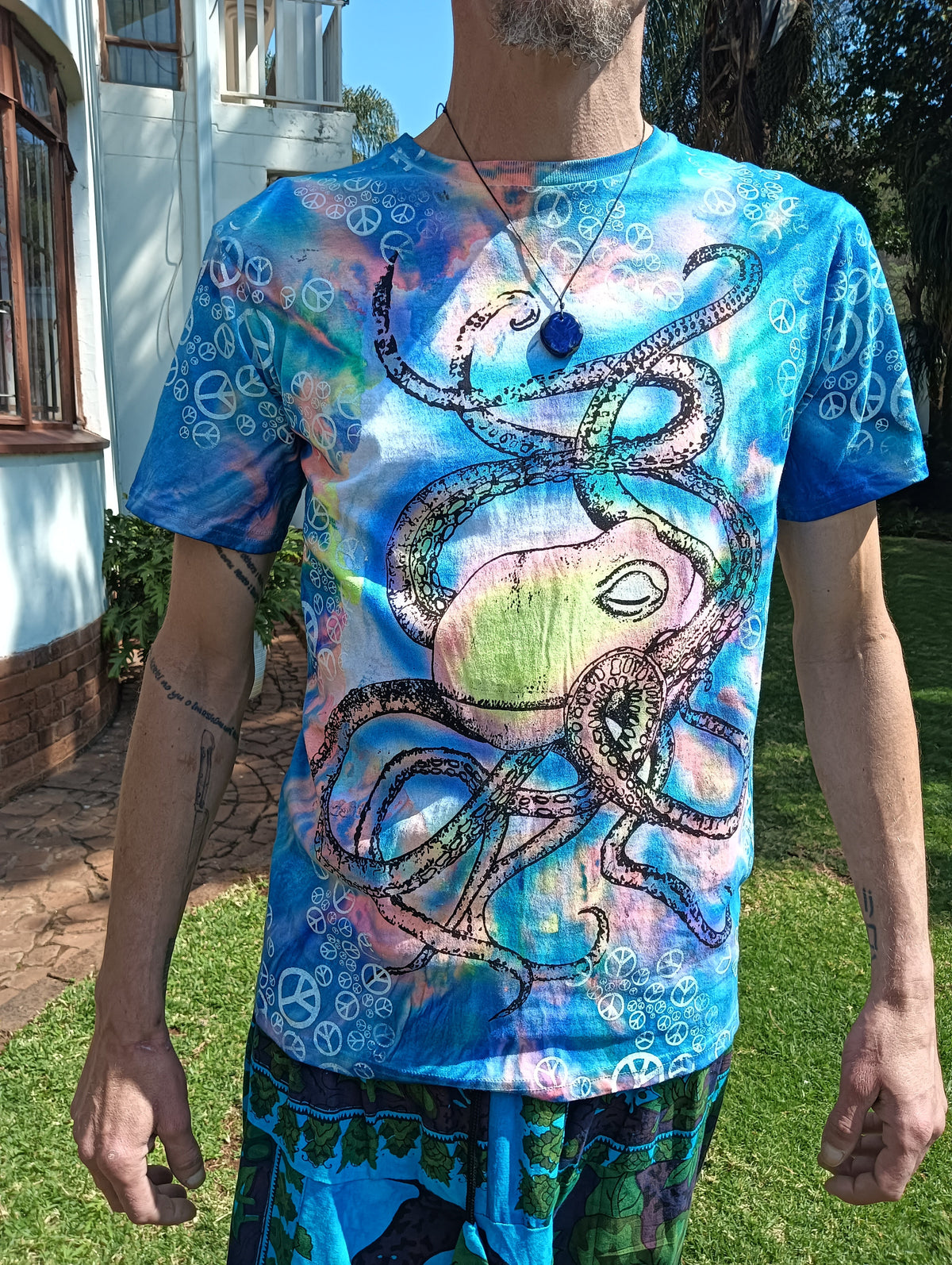 UV Glow Octopus Tie-Dye T-Shirt – close-up front view showing octopus print detail on tie-dye peace sign background