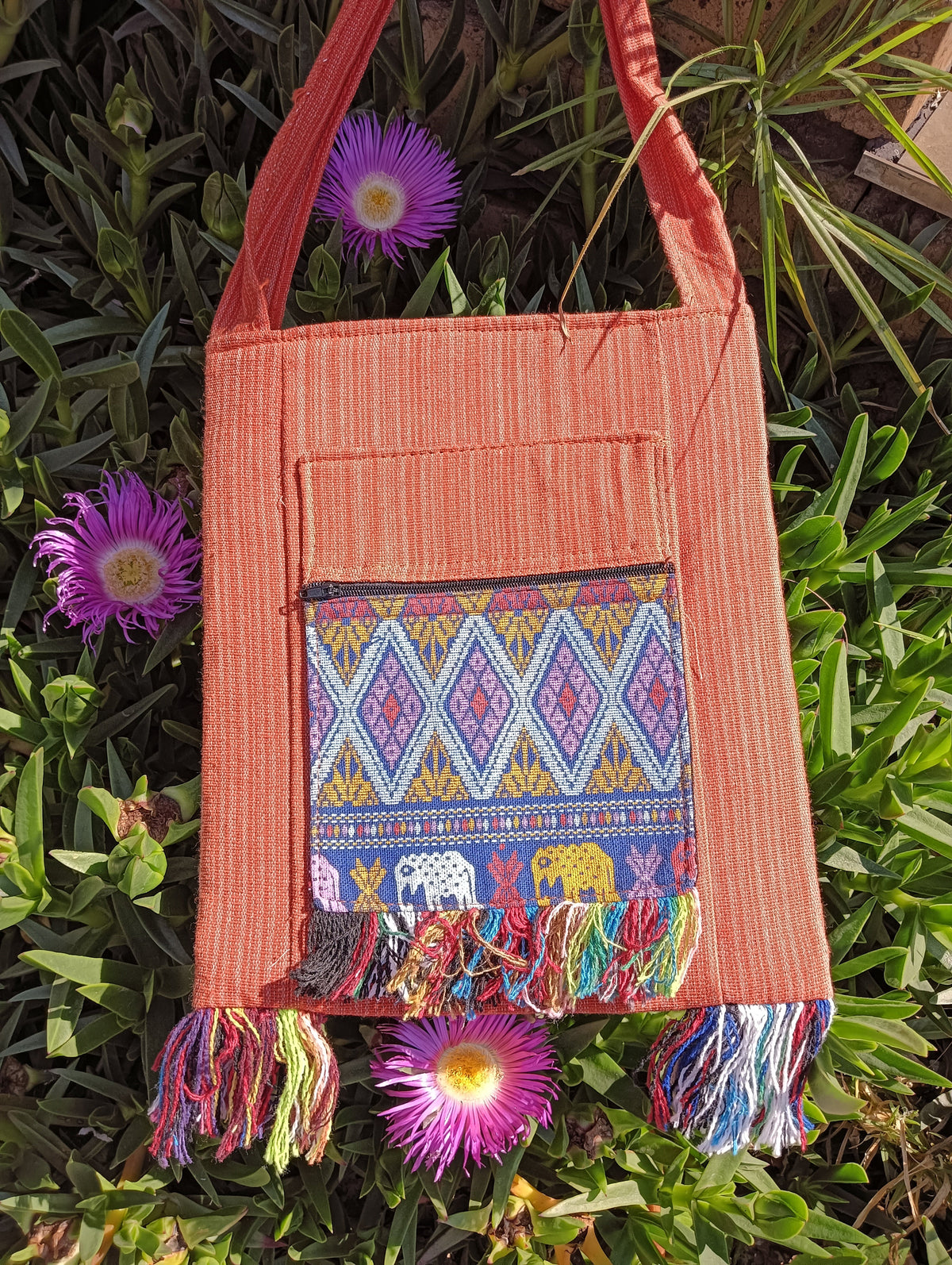Thai Woven Cotton Sling Bag Terracotta and Blue Elephant – front view showing blue diamond geometric and elephant parade woven panel with multicolour fringe