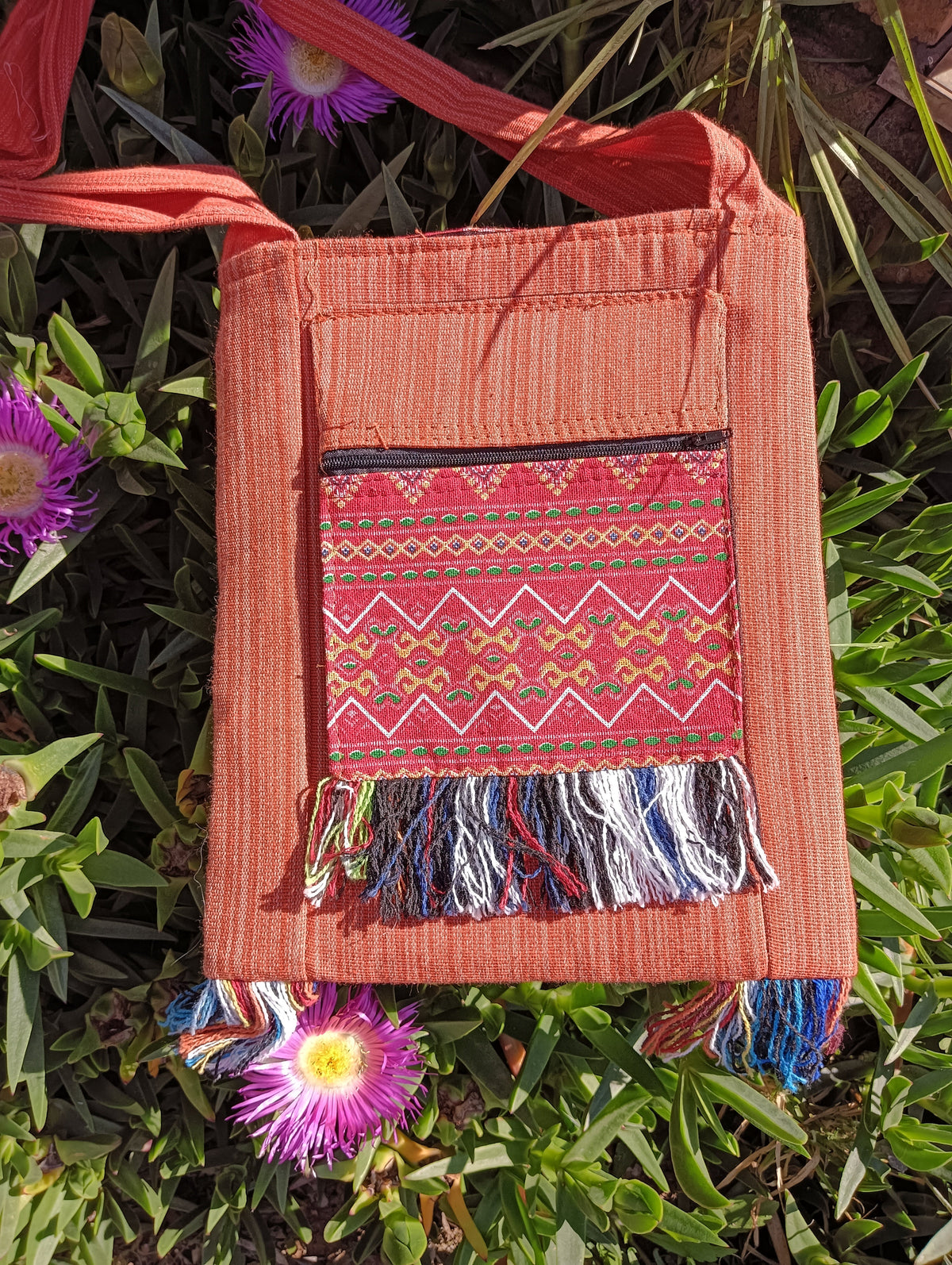 Thai Woven Cotton Sling Bag Terracotta – front view showing zigzag geometric woven panel and multicolour fringe tassels