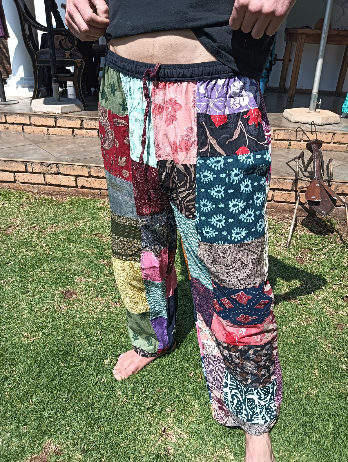 Indian Patchwork Cotton Trousers – front view on male model showing multicolour patchwork panels and elasticated waist