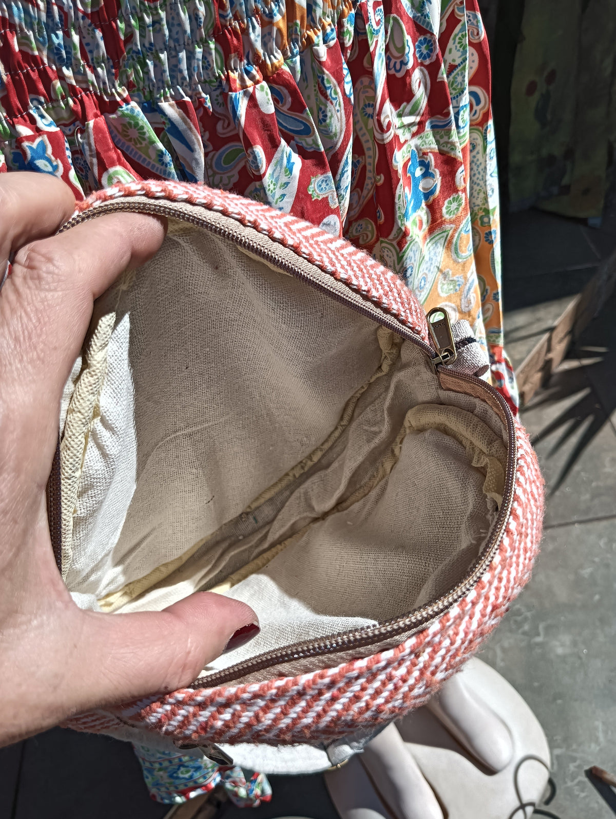 Himalayan Hemp Round Crossbody Bag in Terracotta Red — front view showing herringbone weave and accent stripe