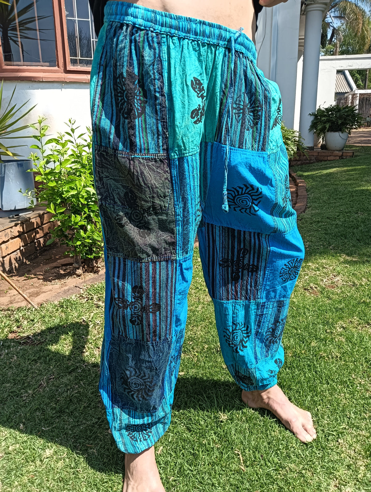 Stonewashed Patchwork Harem Pants in Turquoise – full length front view showing patchwork panels and tapered cuffed ankle