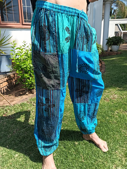 Stonewashed Patchwork Harem Pants in Turquoise – full length front view showing patchwork panels and tapered cuffed ankle