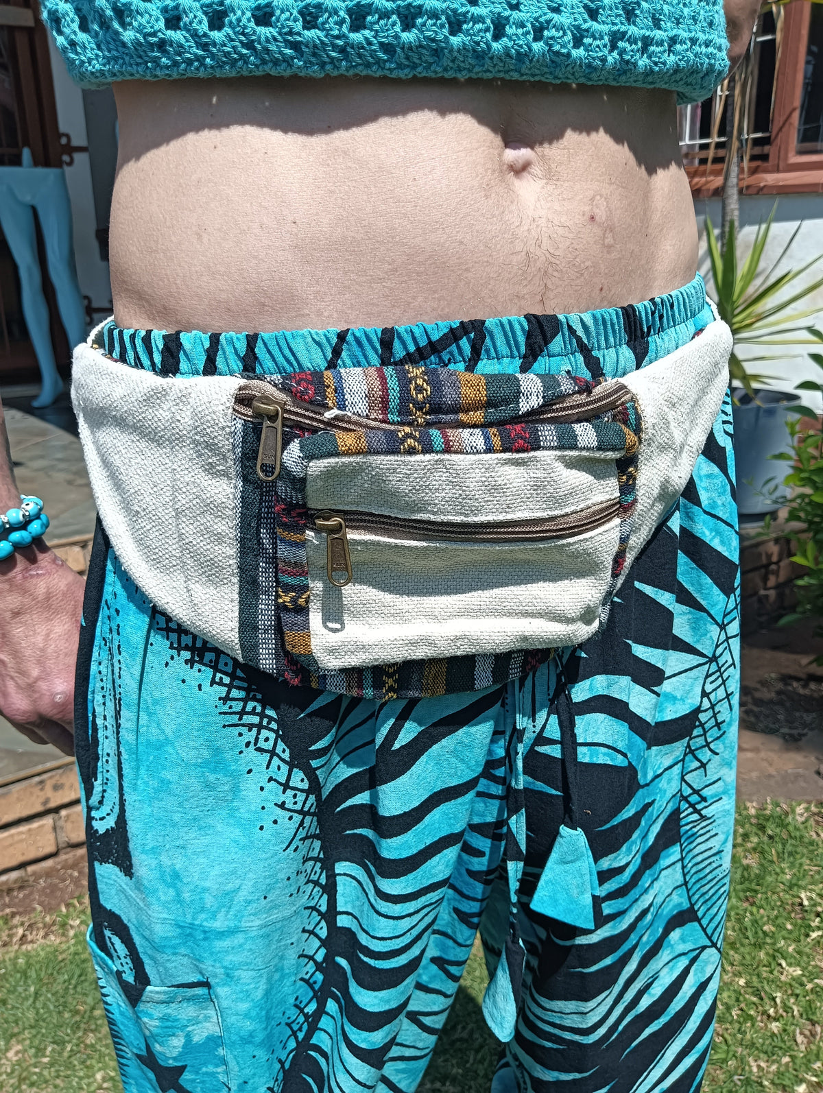 Nepali Hemp Moonbag worn around the waist — showing double zip pockets and tapestry trim detail