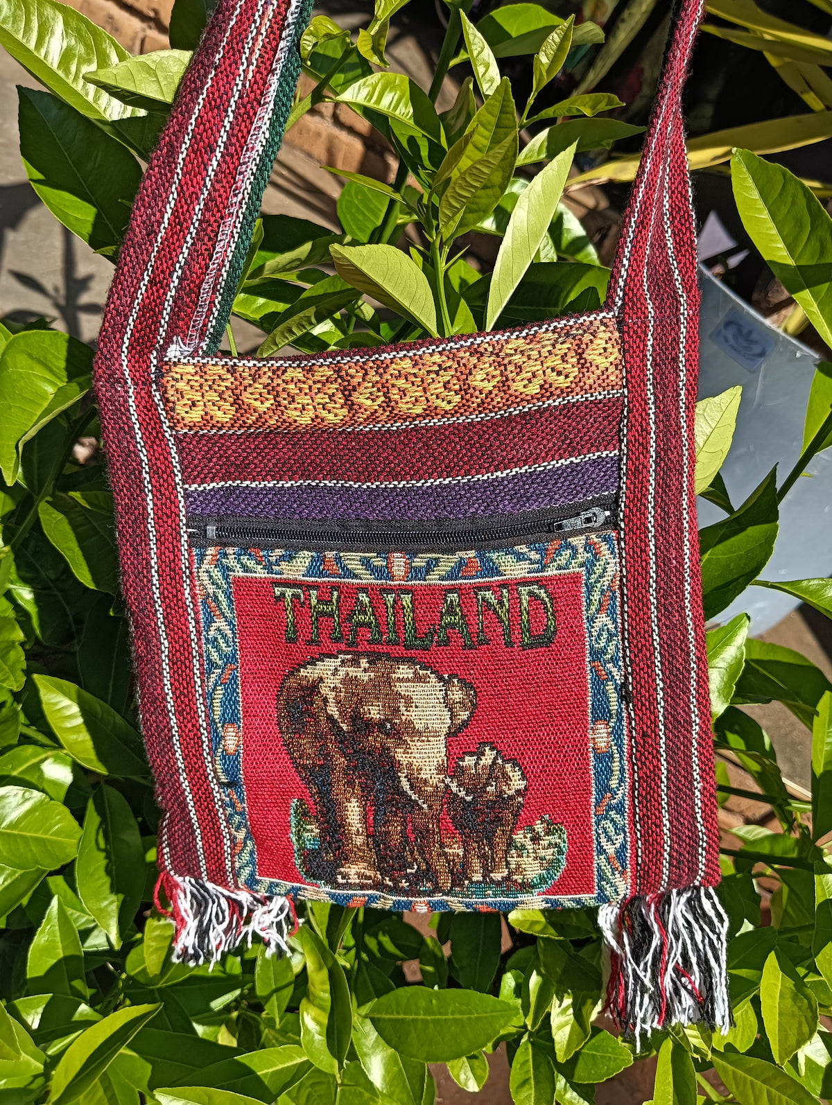 Thai Woven Sling Bag – Thailand Elephant Tapestry Panel — front view showing tapestry pocket, red stripe body and tassel fringe