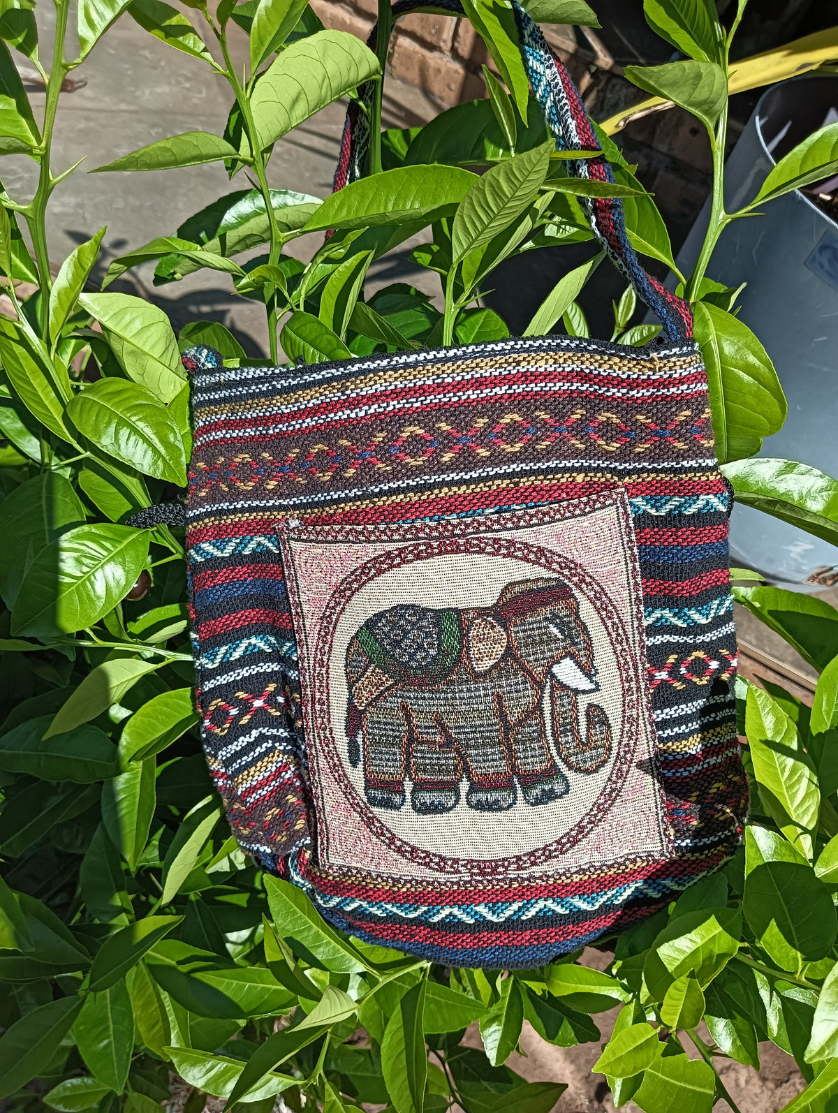 Thai Woven Sling Bag – Elephant Medallion Tapestry — front view showing circular elephant panel and multicolour stripe weave