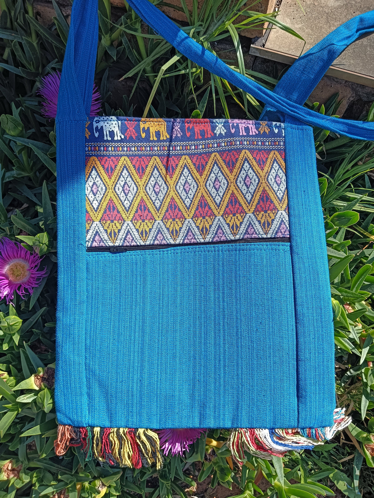 Thai Woven Sling Bag in Turquoise — back view showing plain turquoise body and fringe