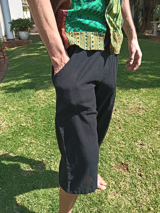 Nepali Long Shorts in Black — side view on model