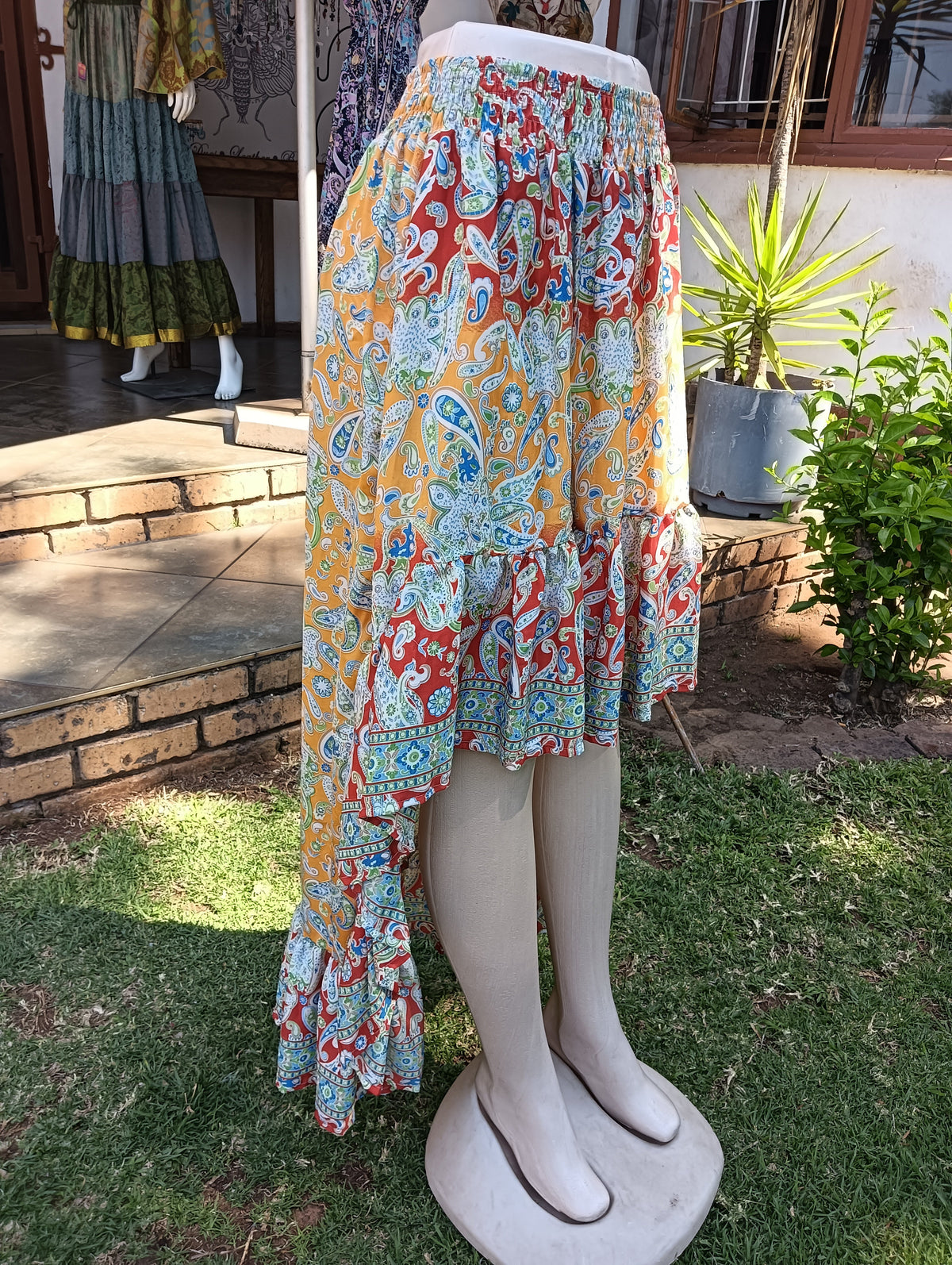 Paisley Poly Silk Hi-Low Frill Skirt — side view showing hi-low hem and ruffle detail