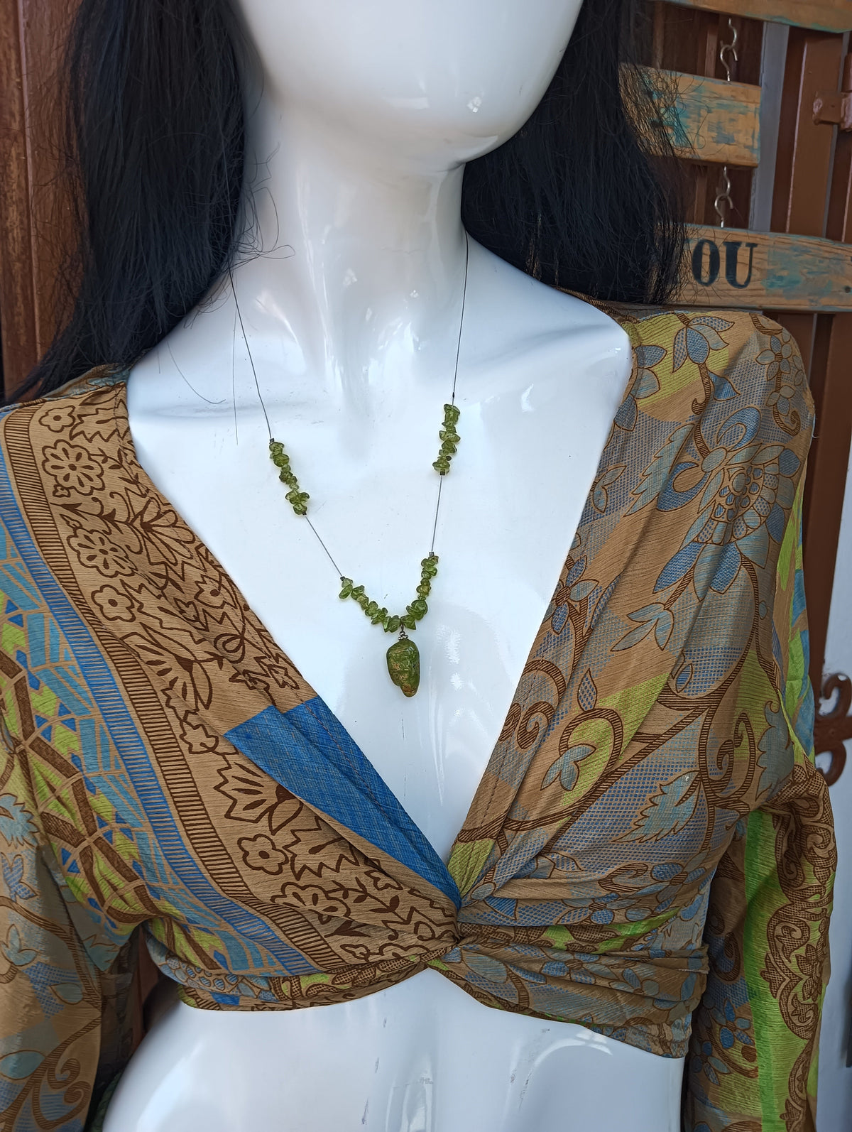 Sari Silk Wrap Crop Top – close-up of deep V neckline and patchwork detail with peridot necklace